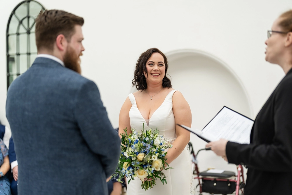 Bride and groom during ceremony in conservatory. Hunton Park wedding photographer.