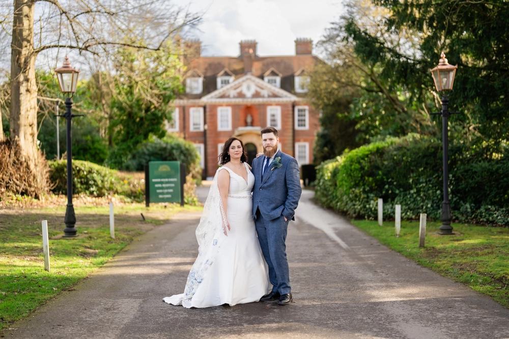 Bride and groom portrait on driveway to hotel. Hunton Park wedding photographer.