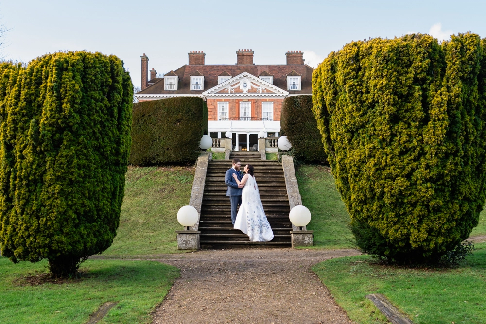 Bride and groom portrait on steps. Hunton Park wedding photographer.