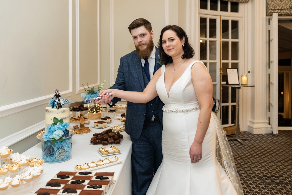 Bride and groom cutting the cake. Hunton Park wedding photographer.
