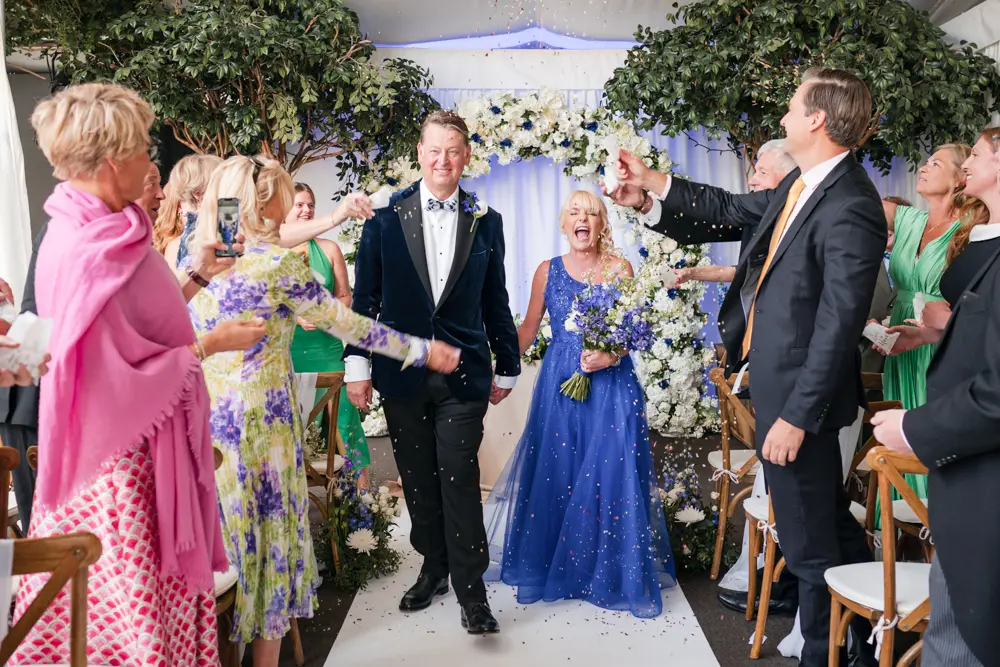 Hurley House Hotel wedding. Bride and groom in confetti tunnel.