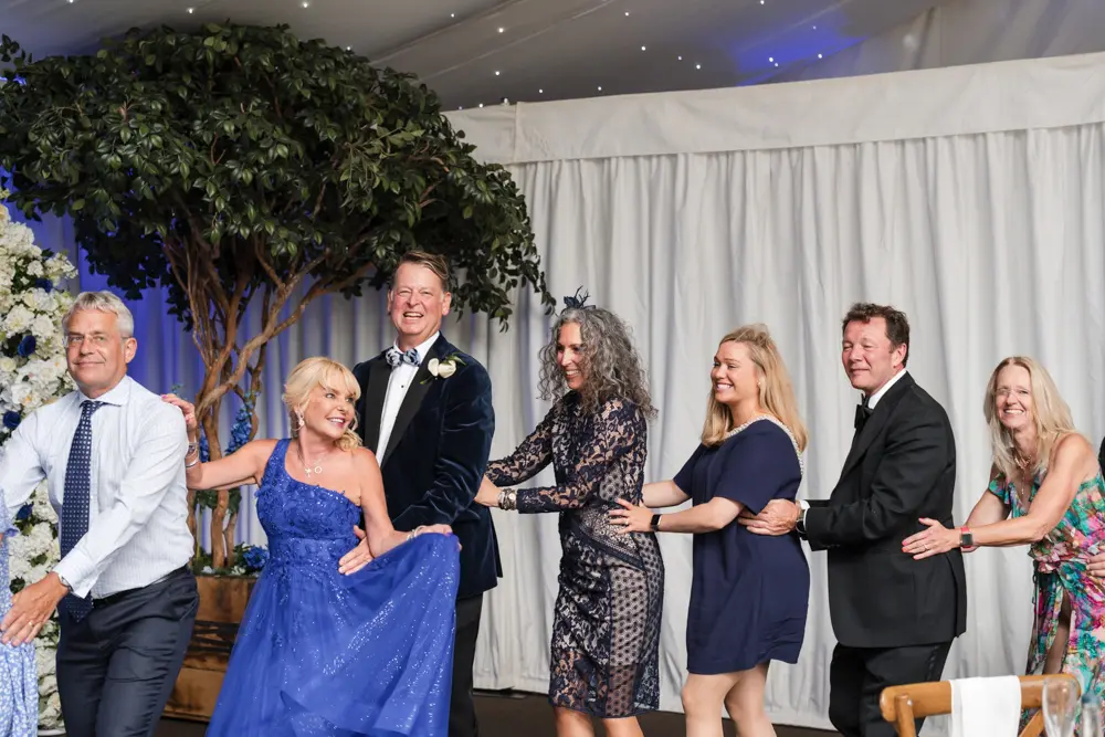 Hurley House Hotel wedding. Guests doing the conga with bride and groom.