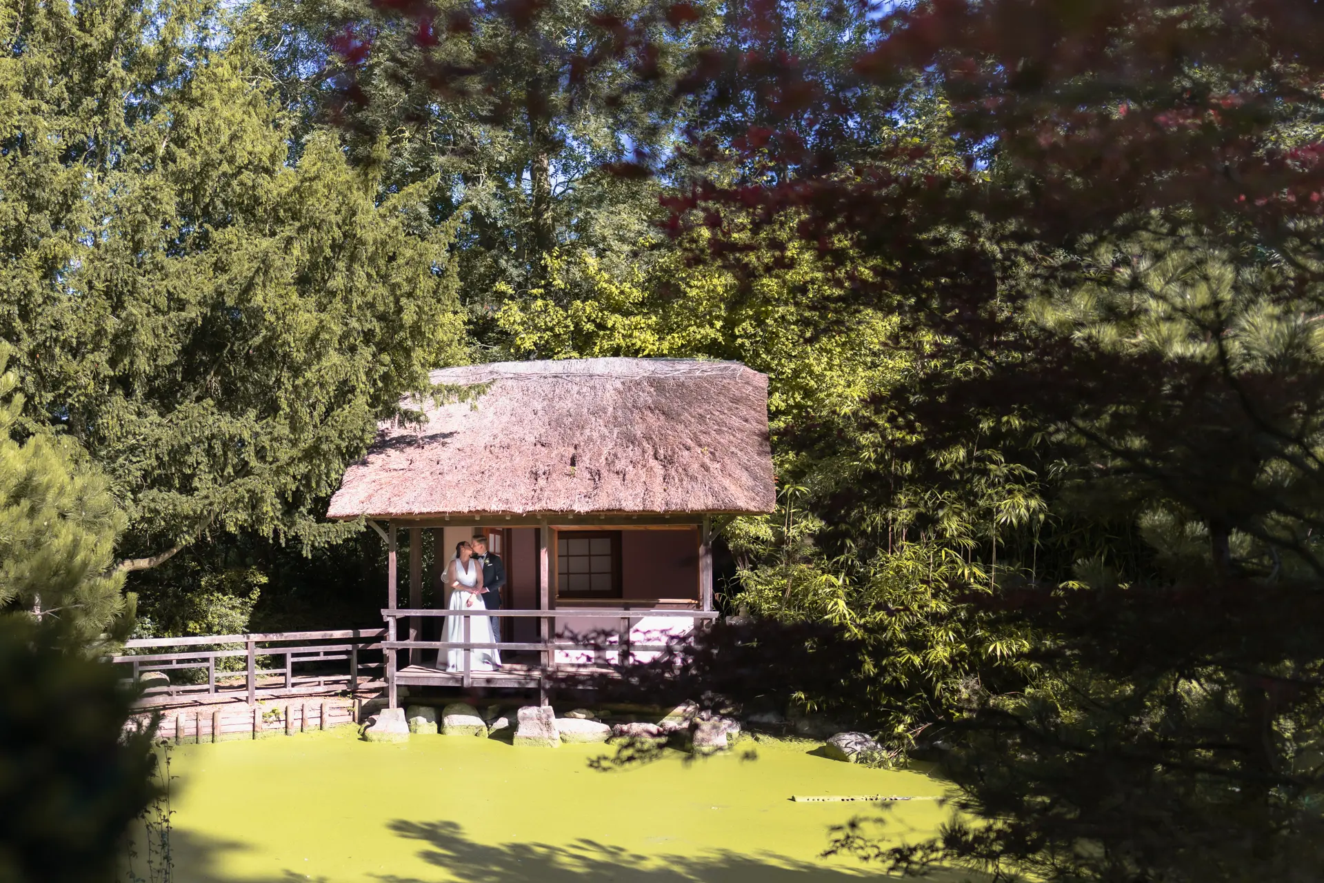 Bride and groom kiss in the Japanese Tea Garden at their Le Manoir wedding.