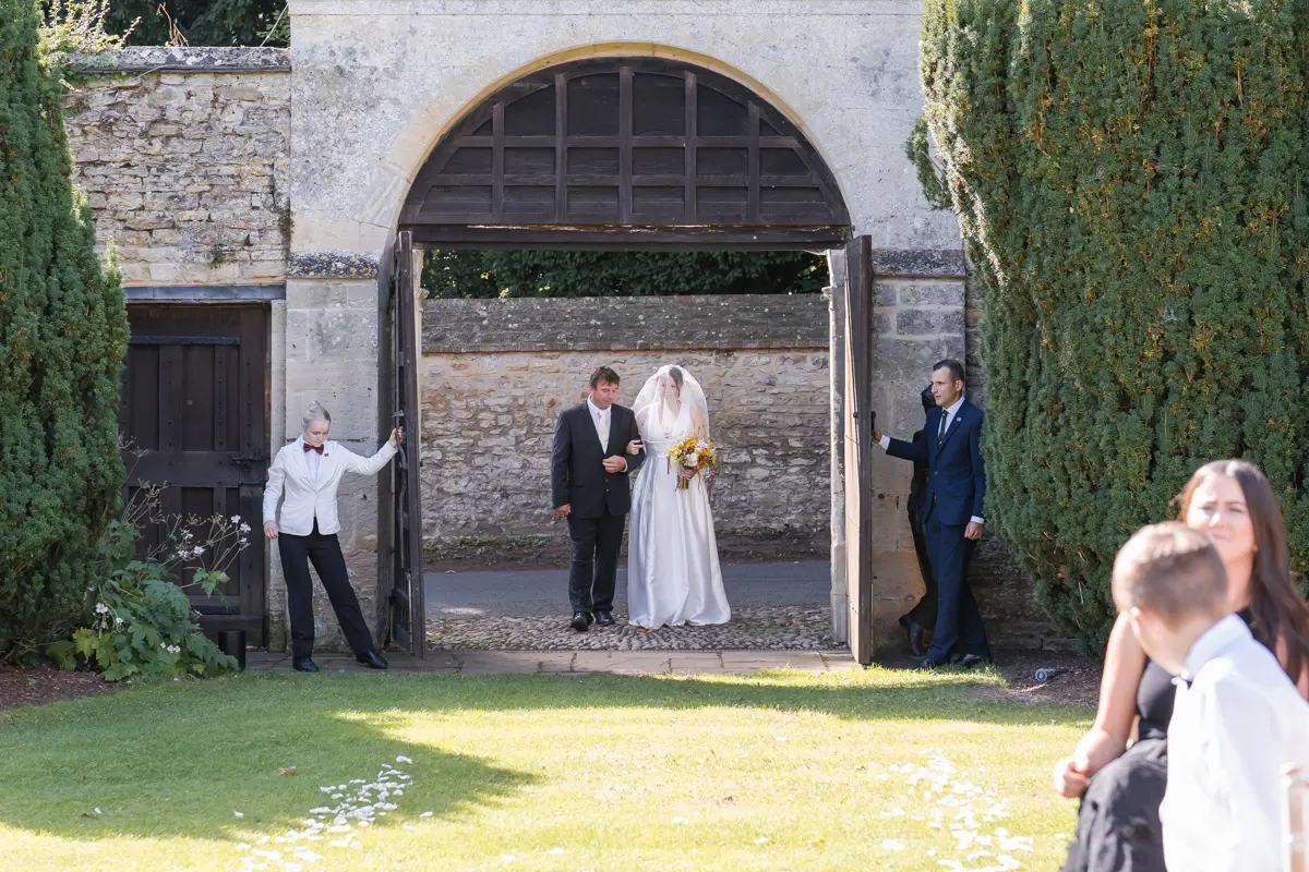 Bride arrives for outdoor ceremony at Le Manoir wedding.