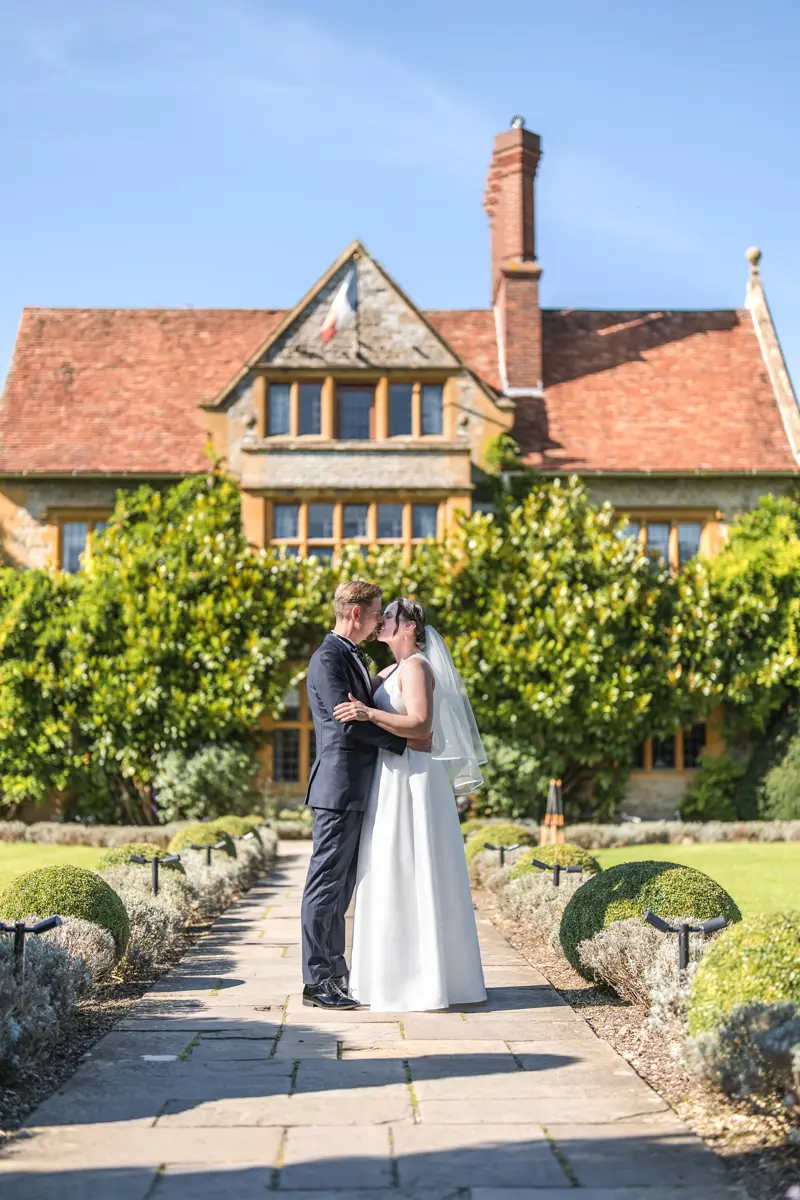 Bride and groom on lavender path at their Le Manoir wedding in September.