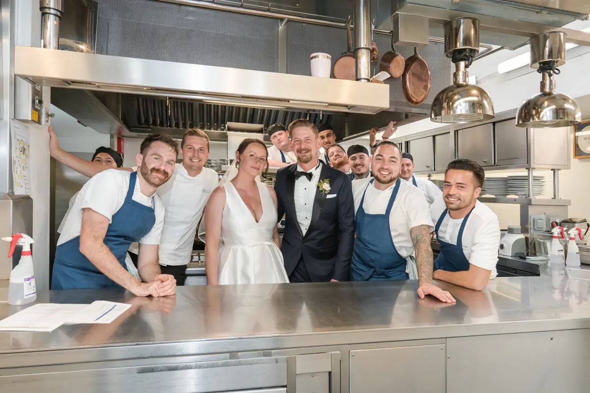 Le Manoir wedding. Bride and groom with kitchen staff at Belmond le manoir aux Quat'Saisons
