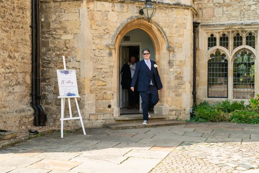 Notley Abbey Wedding photography. Groom coming out of abbey.