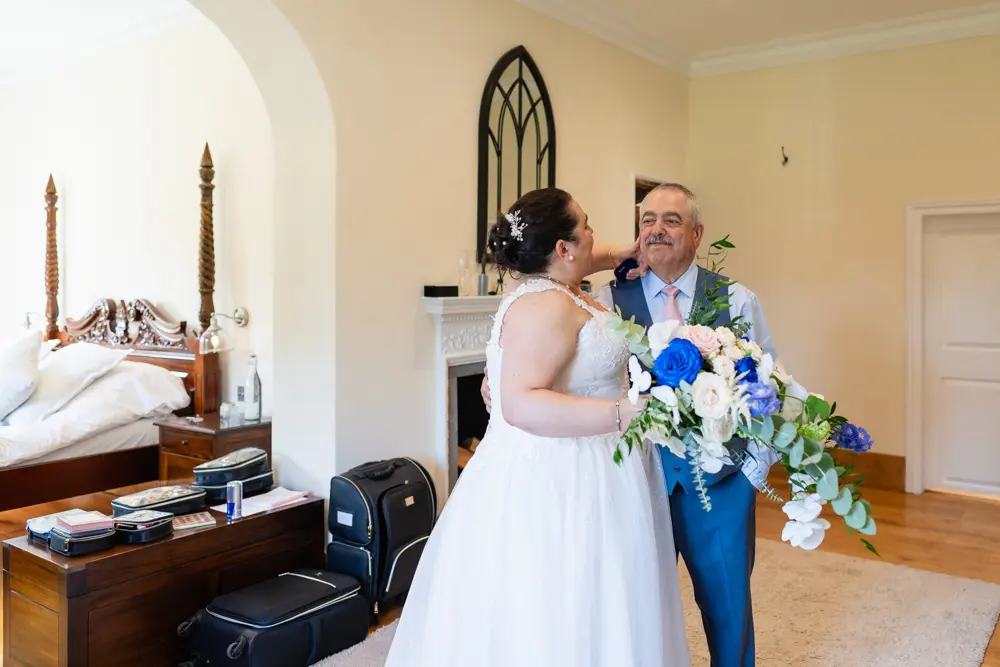 Notley Abbey Wedding photography. Bride kisses father.