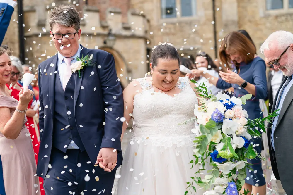 Notley Abbey Wedding photographer. Bride and groom in confetti tunnel at front of the abbey.