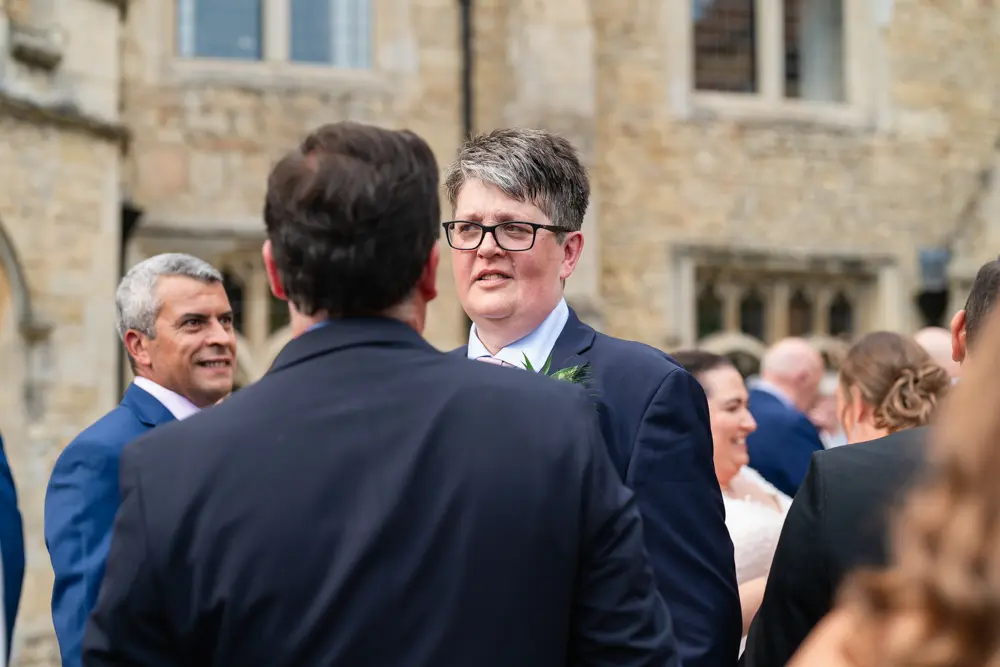 Notley Abbey Wedding photographer. Groom with guests.
