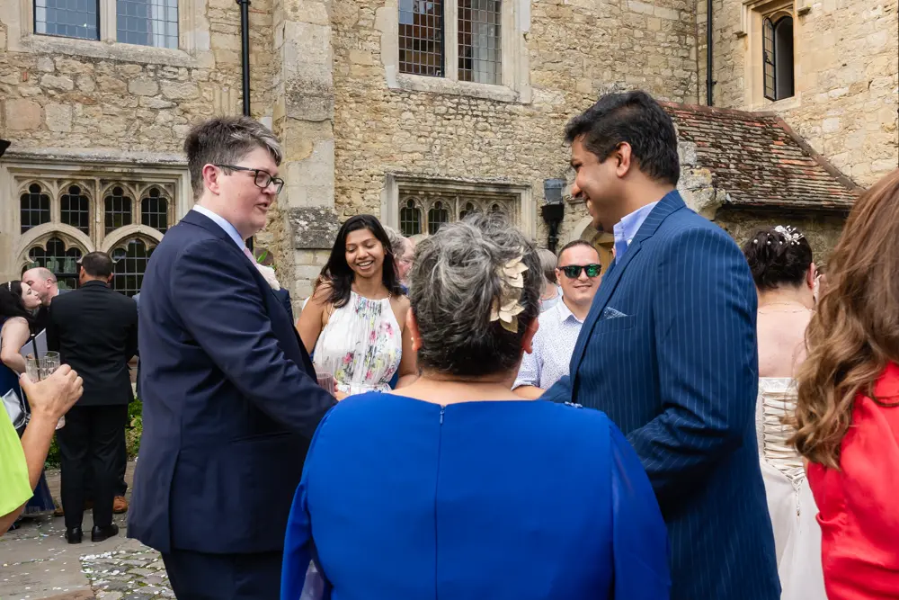 Notley Abbey Wedding photographer. Groom with guests.