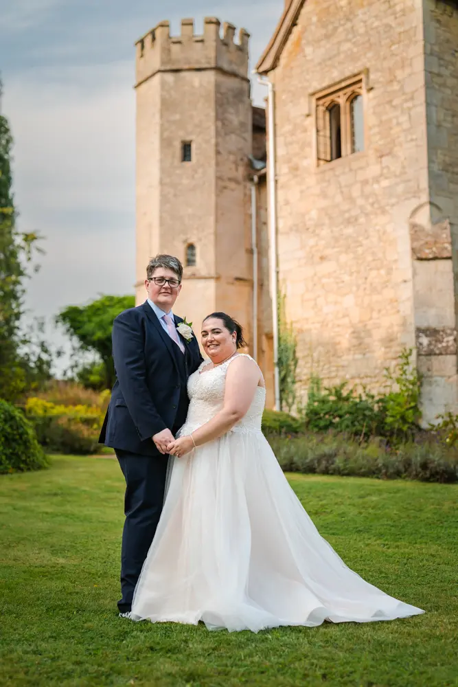 Notley Abbey Wedding photographer. Bride and groom in front of tower.