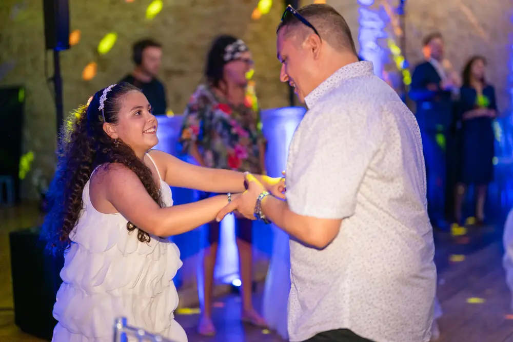Notley Abbey Wedding photographer. Father dances with his young daughter in monk's refectory.