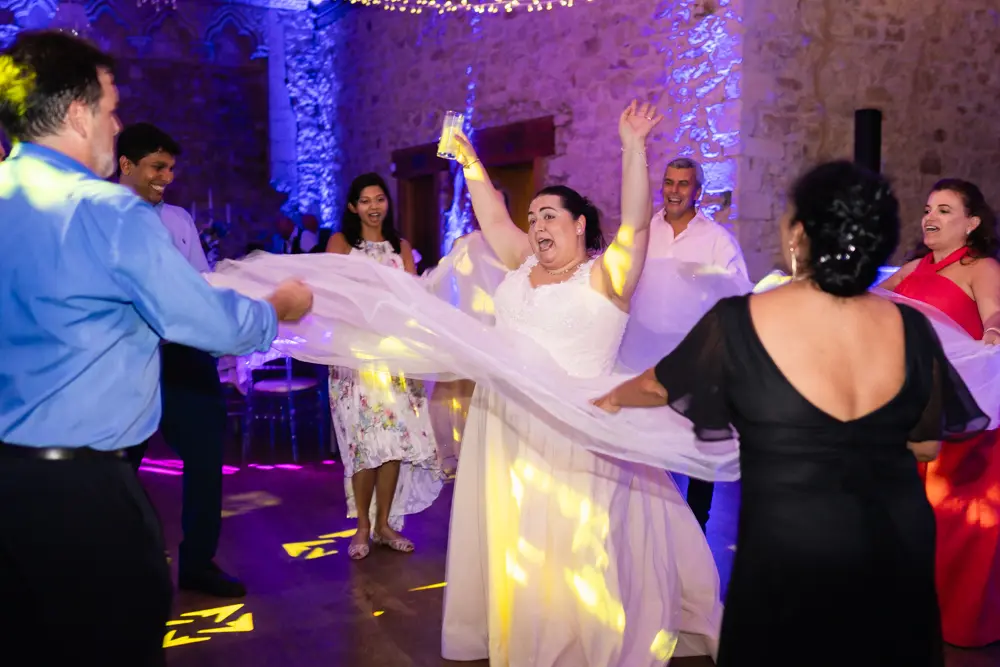 Notley Abbey Wedding photographer. Guests dancing in monk's refectory.