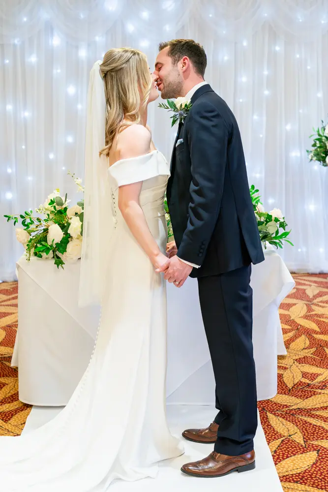 Bull Hotel wedding photography. Bride and groom first kiss.