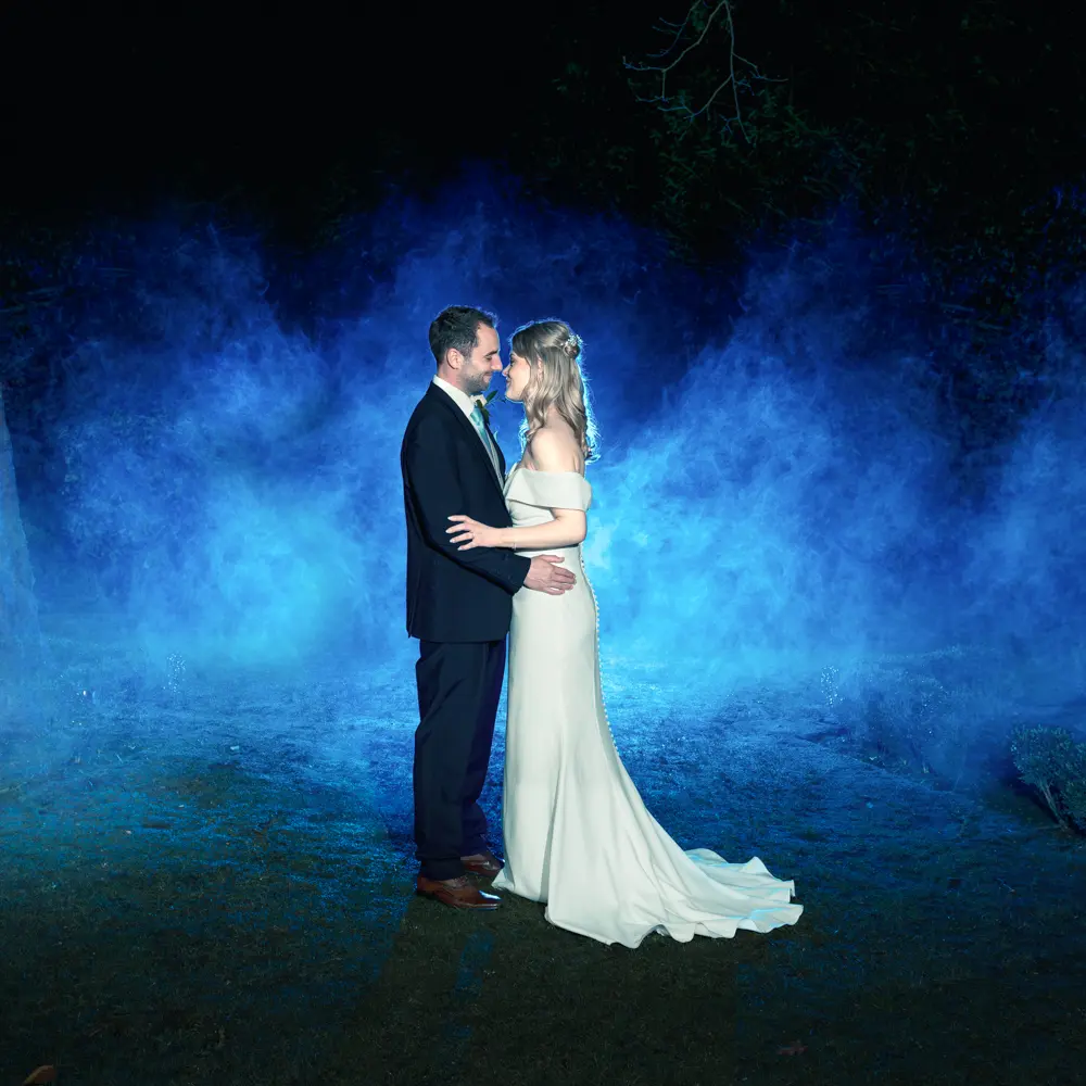 Bull Hotel wedding photography. Bride and groom with blue smoke at night.