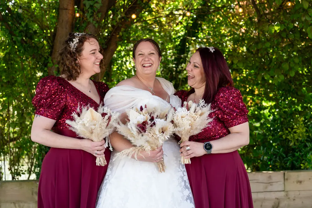 The old mill wedding photographer. Bride and bridesmaids in grounds of the Old mill at Aldermaston.