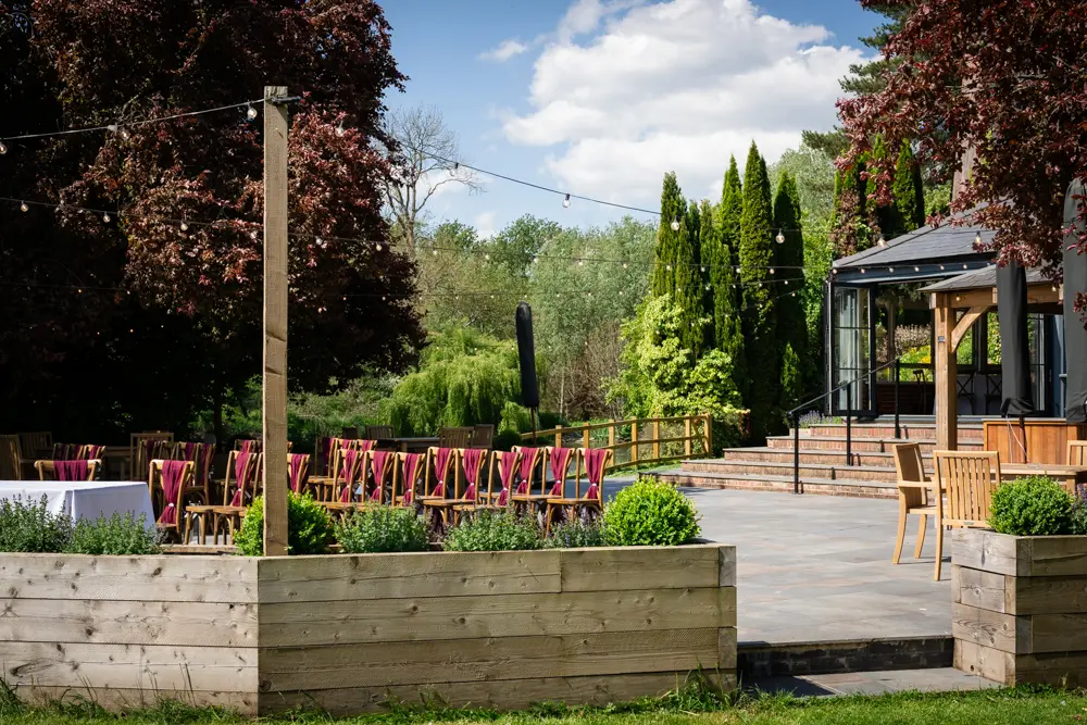 The Old Mill Wedding Photography. View of the outdoor ceremony area and conservatory.