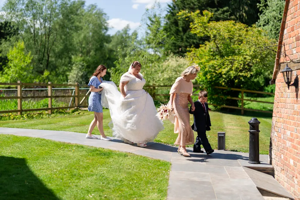 The Old Mill Wedding Photography. Bride leaving mill for ceremony.
