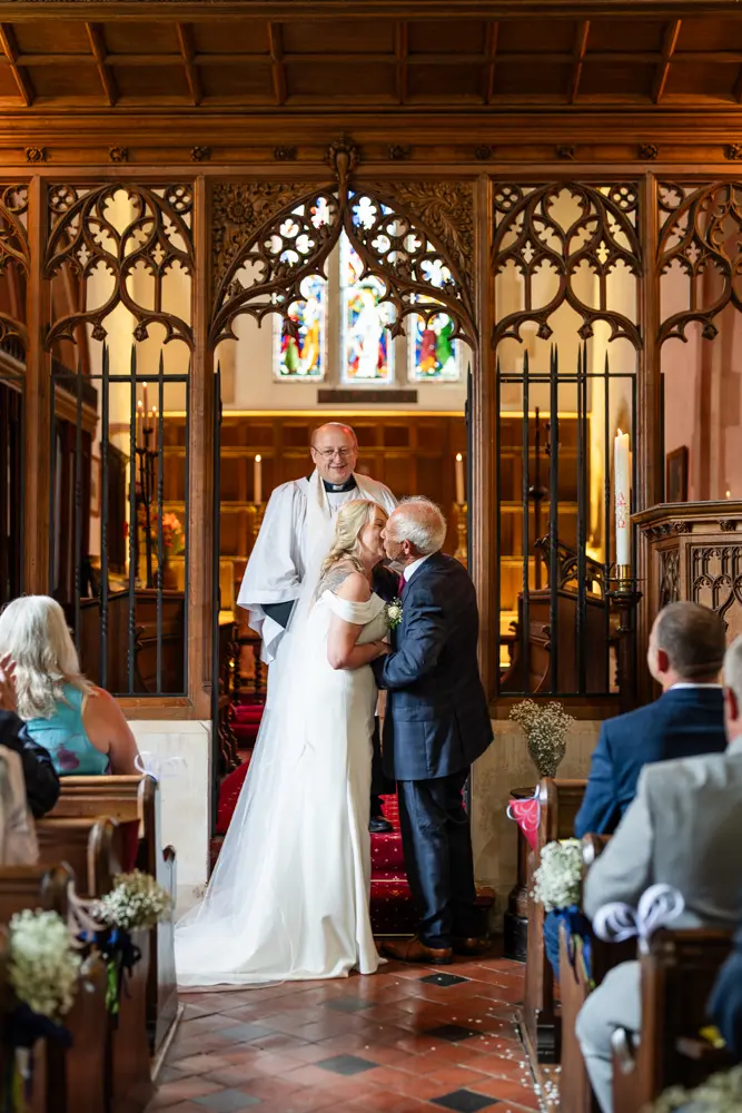 St Boltoph Bradenham wedding photography. Bride and groom first kiss.
