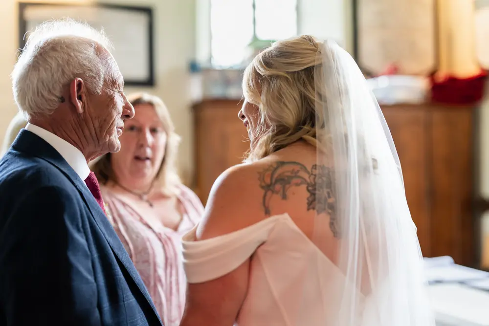 St Boltoph Bradenham wedding photography. Bride and groom during wedding ceremony.