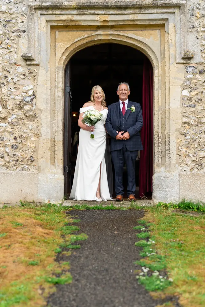 St Boltoph Bradenham wedding photography. Bride and groom leaving church.