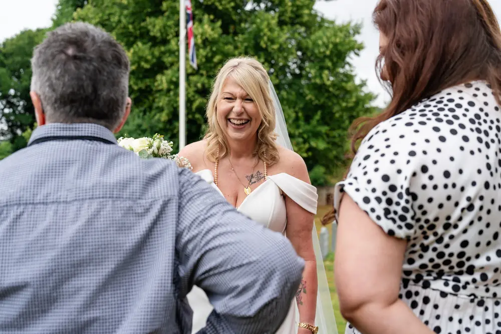 St Boltoph Bradenham wedding photography. Guests outside church.