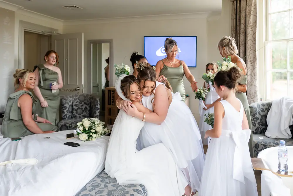 Stoke-Place-Wedding-Photographer. Bride with bridesmaids in bridal suite before wedding ceremony.