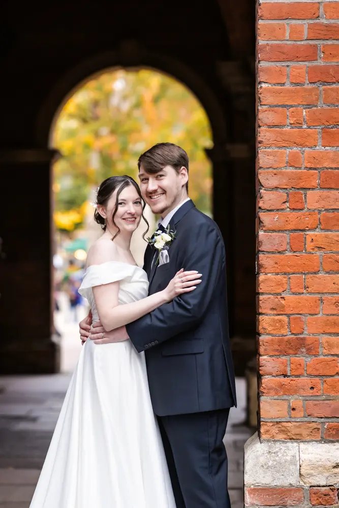 Bride and groom under arches after their Judges Lodgings Aylesbury wedding.