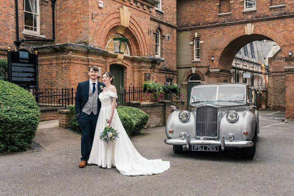 Bride and groom with car outside Judges Lodgings Aylesbury wedding.