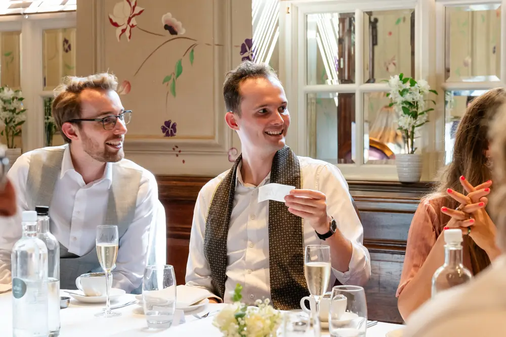 Guests chat at wedding breakfast. Roseate wedding photographer in Reading.