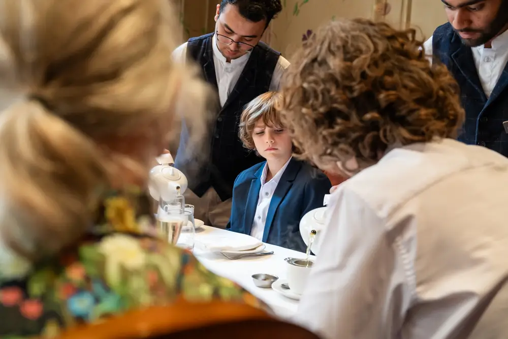 Guests chat at wedding breakfast. Roseate wedding photographer in Reading.