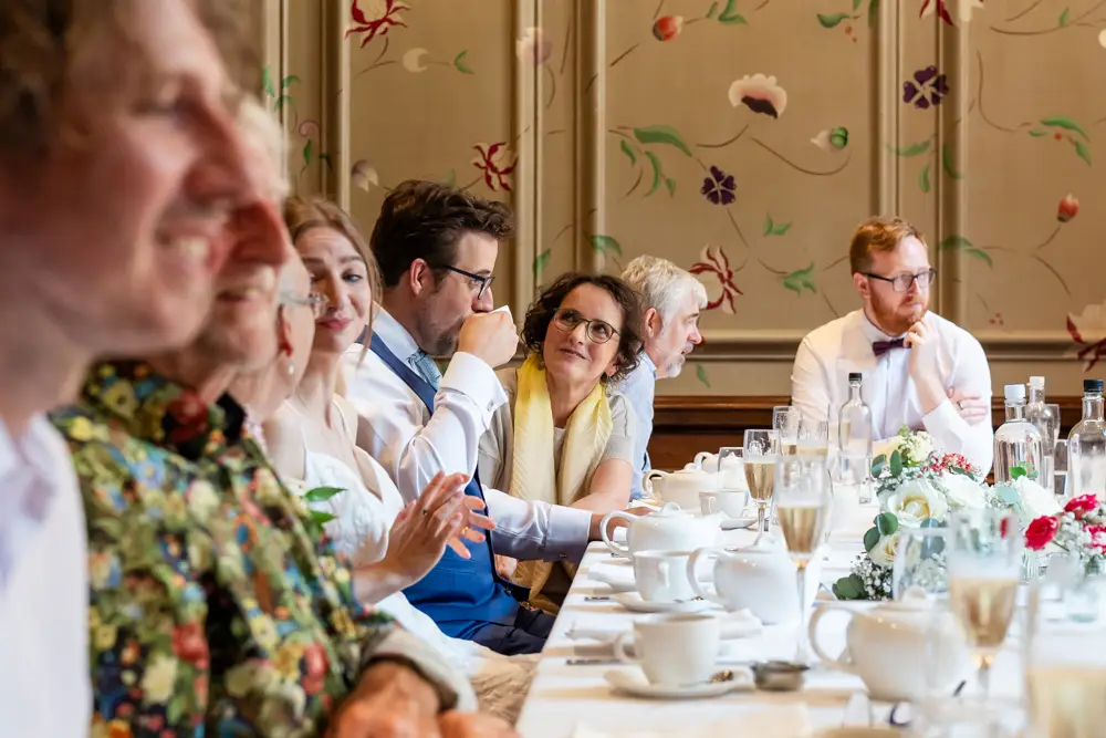 Guests chat at wedding breakfast. Roseate wedding photographer in Reading.