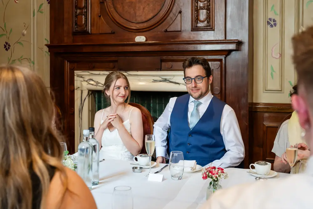 bride and groom at wedding breakfast. Roseate wedding photographer in Reading.