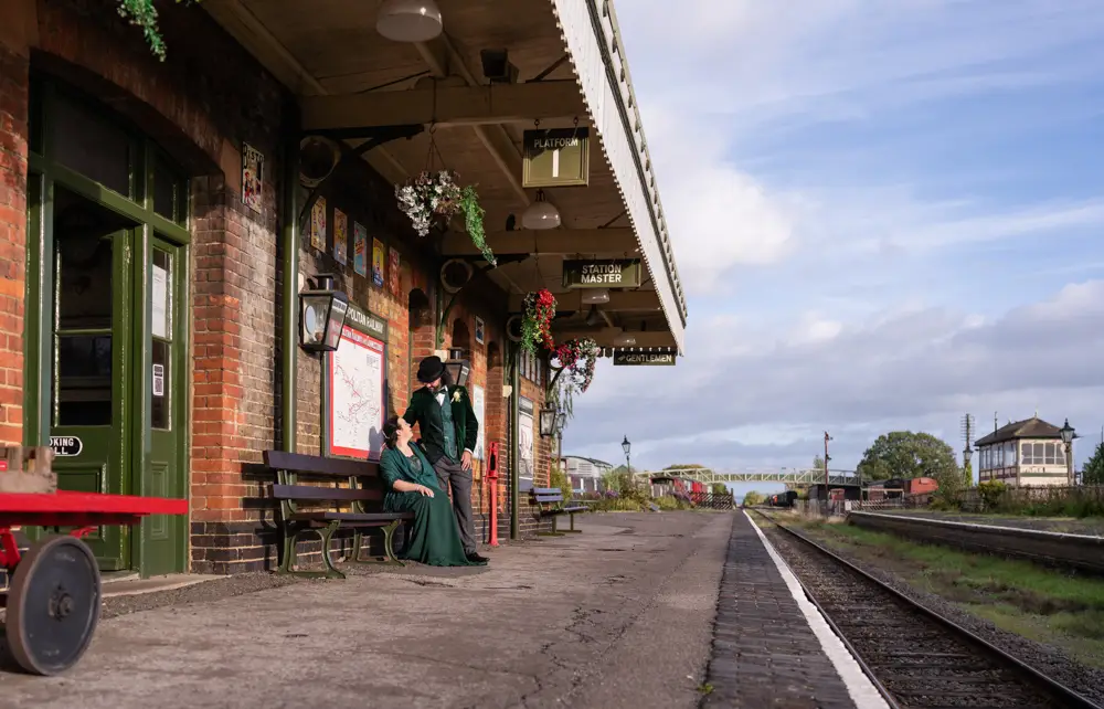 Buckinghamshire Railway Centre Wedding Photographer. Bride and groom at sunset next to royal mail train on platform 1