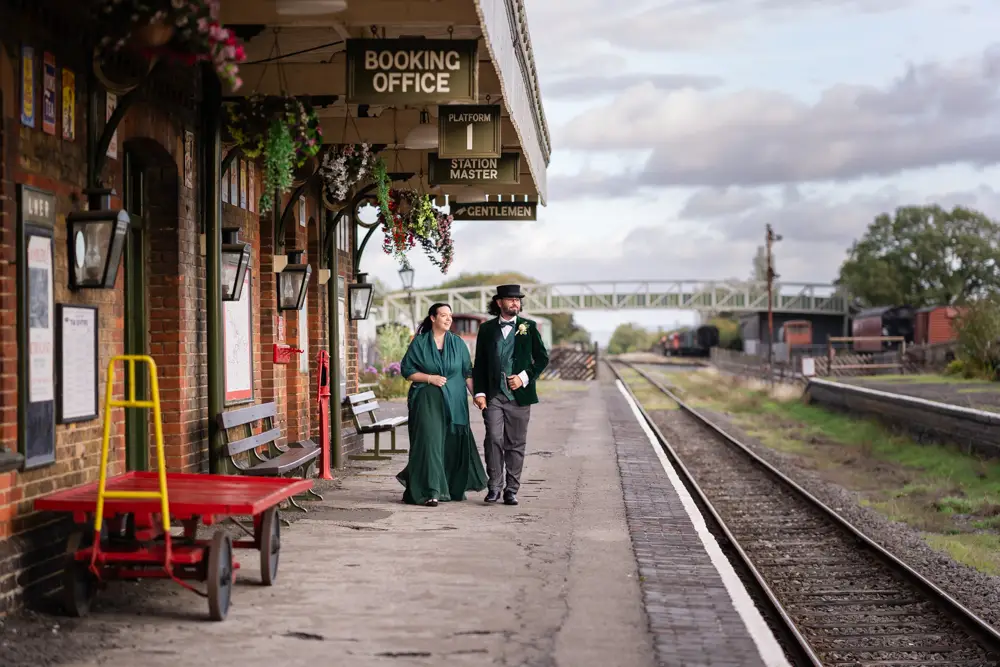 Buckinghamshire Railway Centre Wedding Photographer. Bride and groom at sunset walking on platform 1