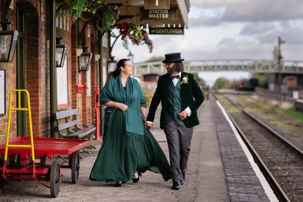 Buckinghamshire Railway Centre Wedding Photographer. Bride and groom at sunset walking on platform 1