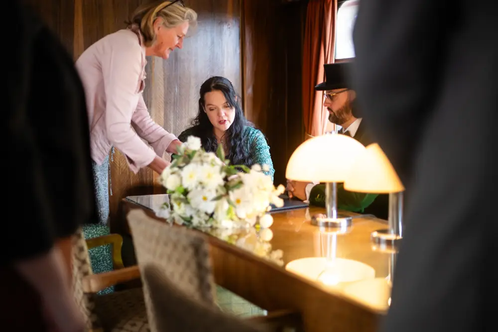 Buckinghamshire Railway Centre Wedding Photographer. Bride and groom signing registry.