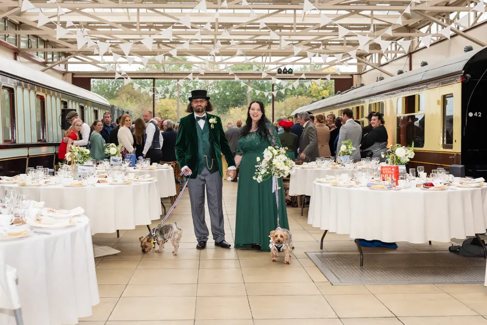 Buckinghamshire Railway Centre Wedding Photographer. Bride and groom with two yorkies at the end of wedding ceremony