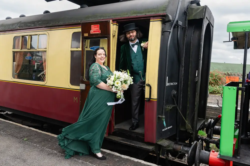 Buckinghamshire Railway Centre Wedding Photographer. Bride and groom next to steam train.