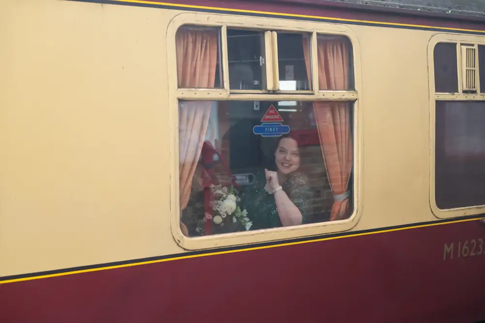 Buckinghamshire Railway Centre Wedding Photographer. Bride and groom on steam train.