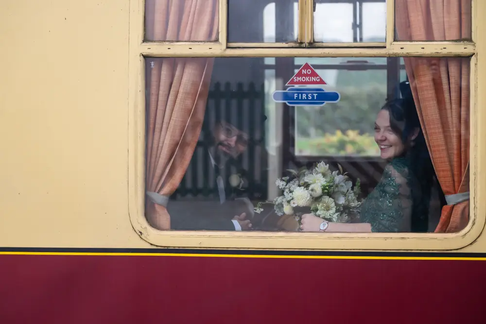 Buckinghamshire Railway Centre Wedding Photographer. Bride and groom on steam train.