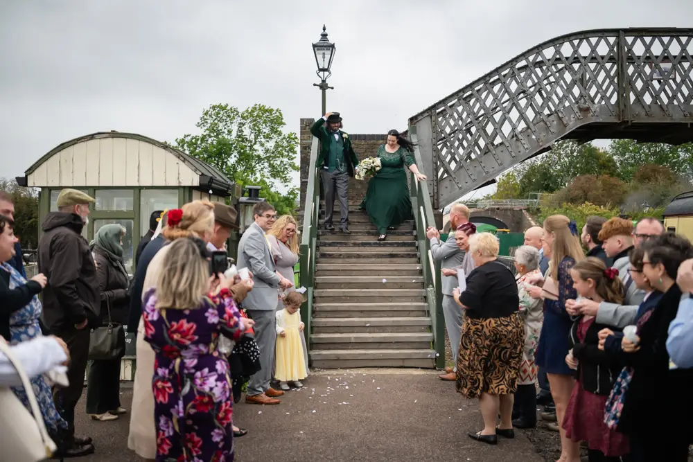 Buckinghamshire Railway Centre Wedding Photographer. Bride and groom confetti tunnel on Platform 2.