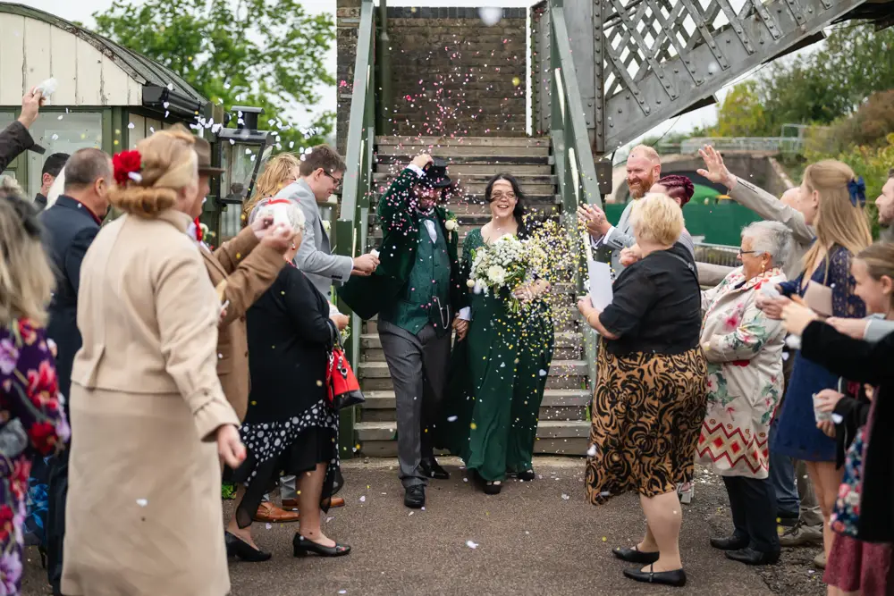 Buckinghamshire Railway Centre Wedding Photographer. Bride and groom confetti tunnel on Platform 2.