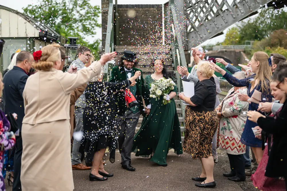 Buckinghamshire Railway Centre Wedding Photographer. Bride and groom confetti tunnel on Platform 2.