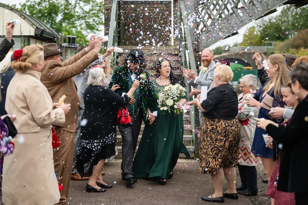 Buckinghamshire Railway Centre Wedding Photographer. Bride and groom confetti tunnel on Platform 2.