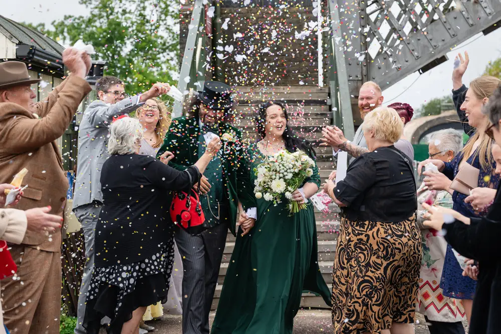 Buckinghamshire Railway Centre Wedding Photographer. Bride and groom confetti tunnel on Platform 2.