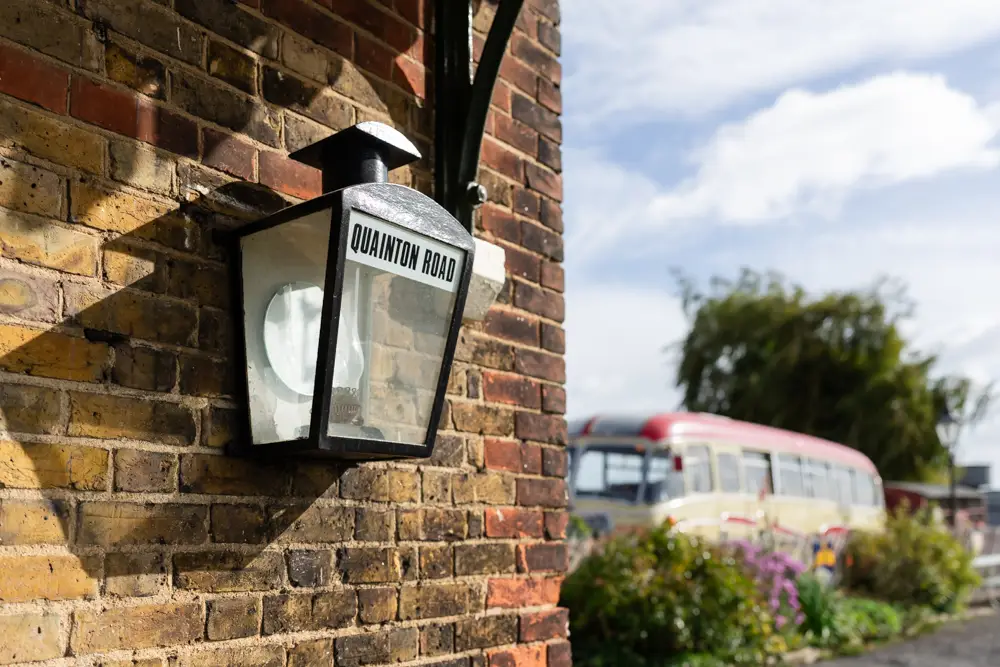 Bucks Railway Centre. Lamp with Quainton Road signage and coach in background.