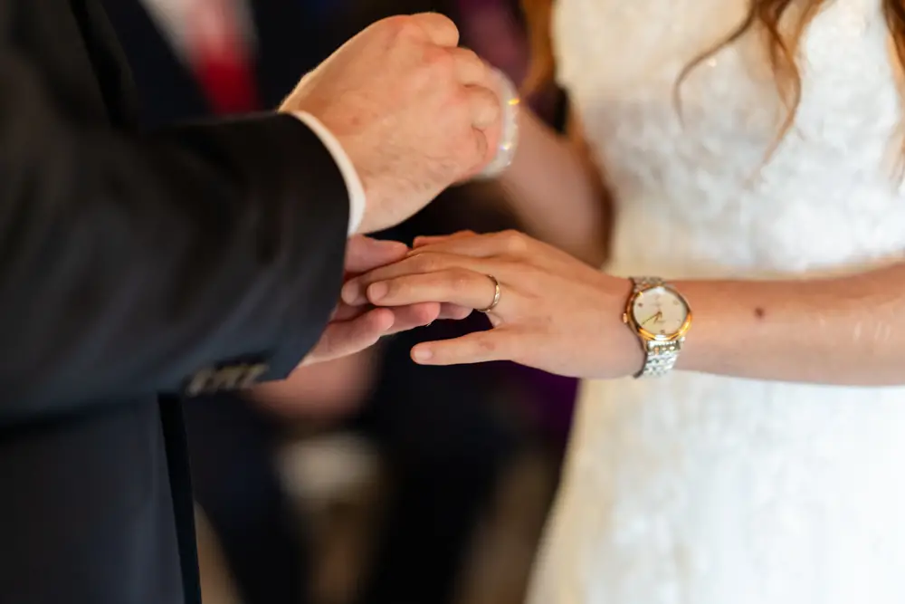 Notley Tythe Barn Wedding Photography. Bride and groom during wedding ceremony in barn.