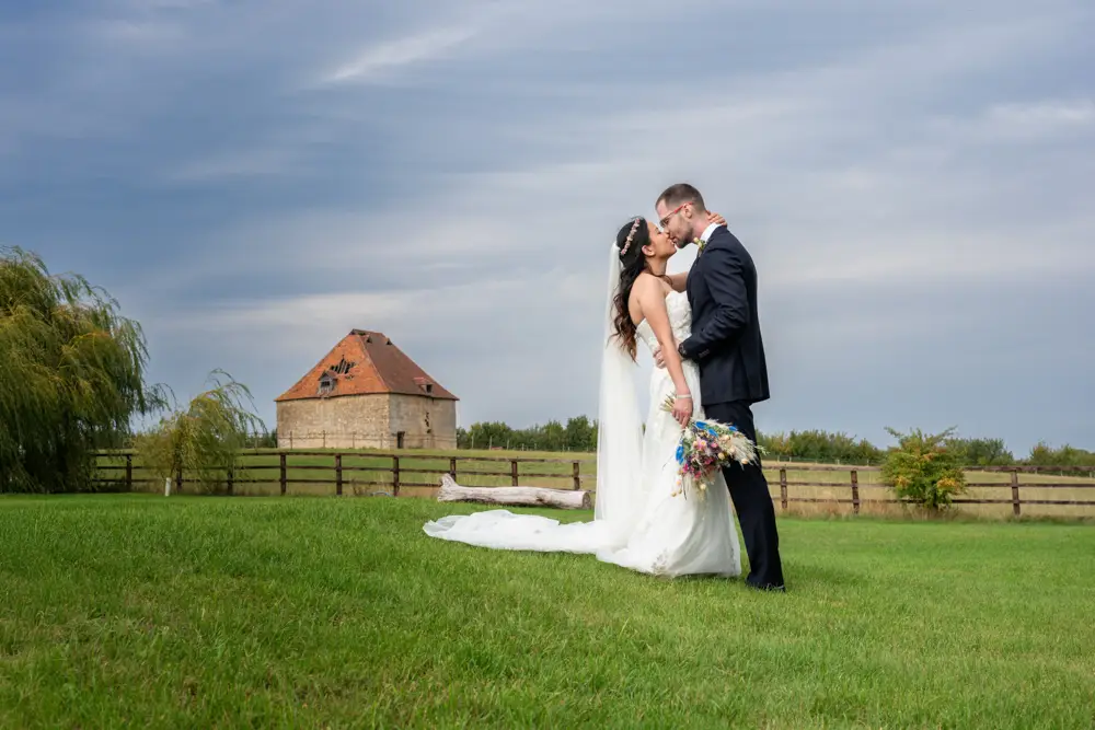 Notley Tythe Barn Wedding Photography. Bride and groom next to the dovecot at Notley Tythe Barn near aylesbury in Buckinghamshire.